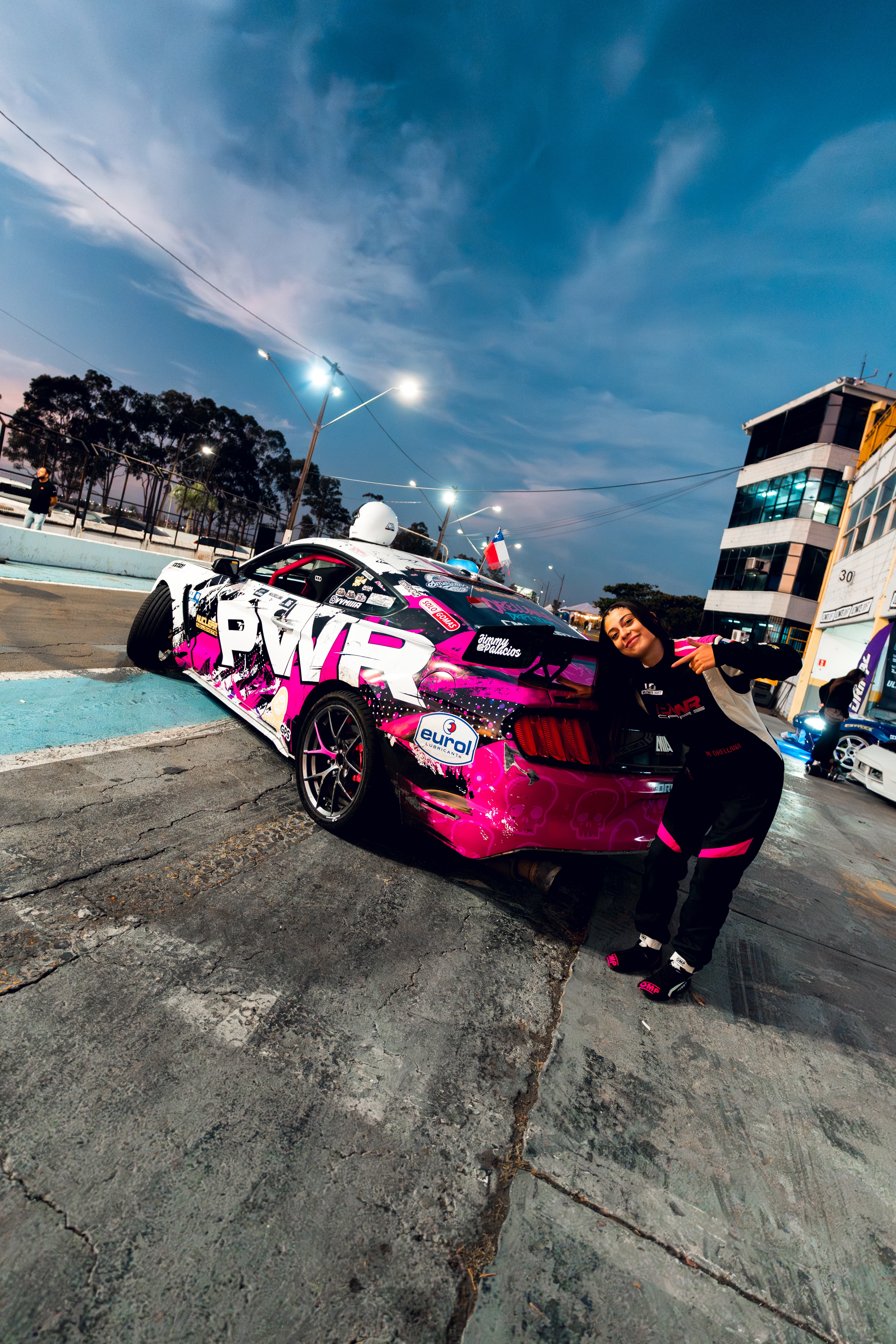 Mía Orellana junto a su Mustang en el autódromo